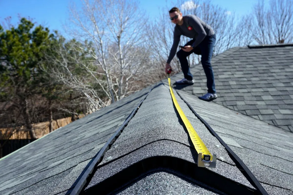 roof contractor measuring roof design